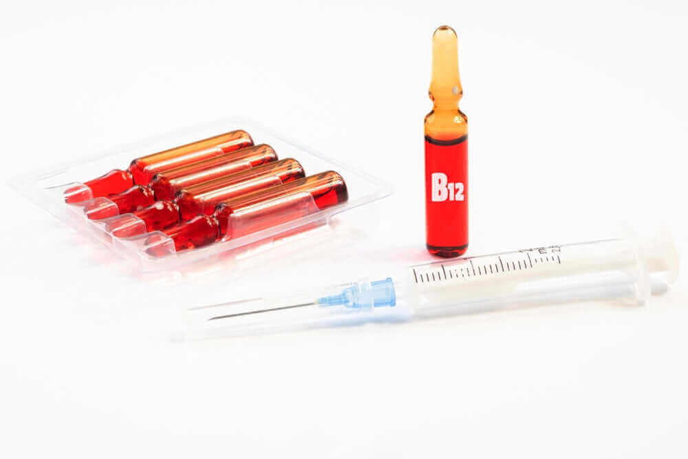 Vitamin B12 vial in red with a syringe, illustrating the benefits of B12 injections for energy, weight loss, and nerve health.