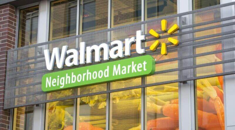 Exterior view of a Walmart Neighborhood Market with the green and white logo, entrance doors